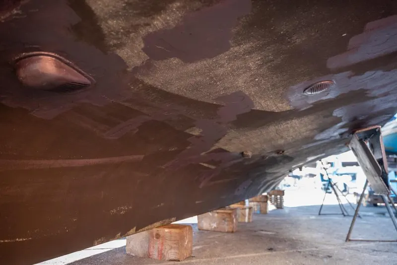 Slide: The Image of Underside of 1988 Hatteras 65 Sportfish boat on blocks, showing hull details. - 56