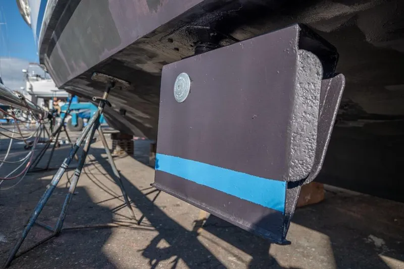 Slide: The Image of 1988 Hatteras 65 Sportfish boat hull detail with stabilizer fin in dry dock. - 58