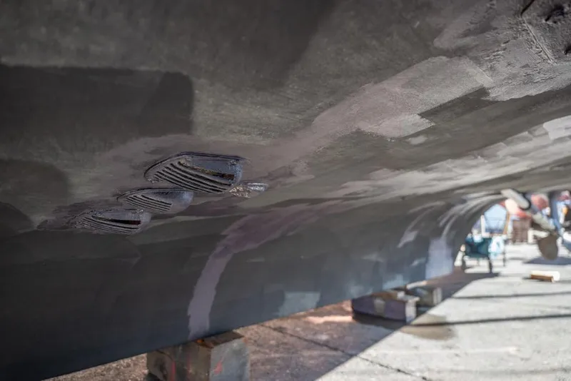 Slide: The Image of Underside view of a 1988 Hatteras 65 Sportfish boat hull in dry dock. - 59