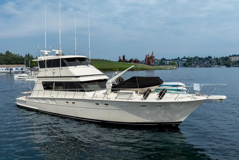 Slide: The Image of 1988 Hatteras 65 Sportfish yacht on calm water, scenic background. - 6