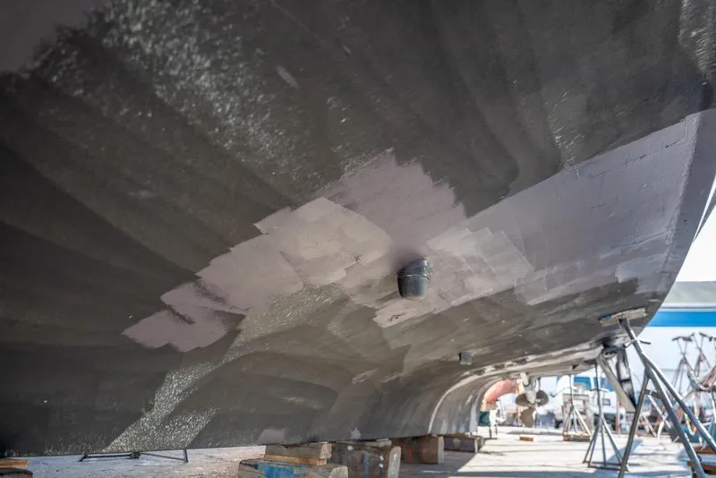 Slide: The Image of 1988 Hatteras 65 Sportfish undergoing hull maintenance in a boatyard. - 61