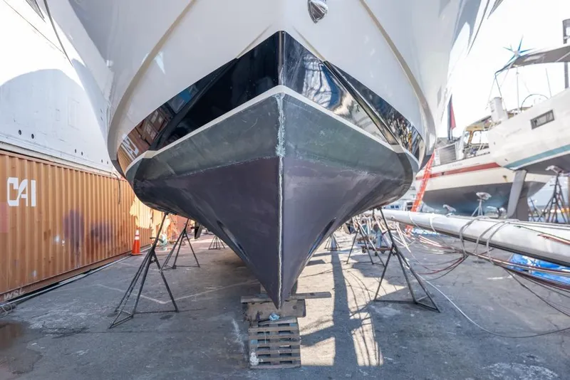 Slide: The Image of 1988 Hatteras 65 Sportfish yacht in dry dock, viewed from the bow. - 62