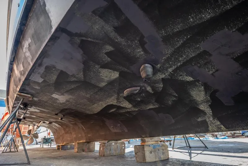 Slide: The Image of Underside view of 1988 Hatteras 65 Sportfish boat on dry dock. - 64
