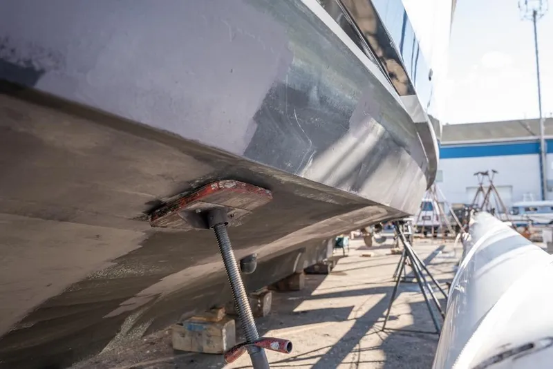 Slide: The Image of 1988 Hatteras 65 Sportfish boat under maintenance in a shipyard. - 67