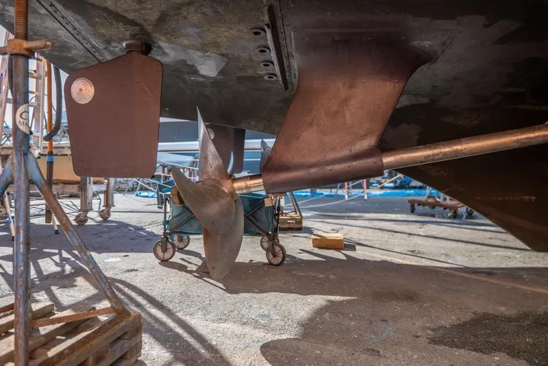 Slide: The Image of 1988 Hatteras 65 Sportfish propeller and rudder in dry dock maintenance. - 72