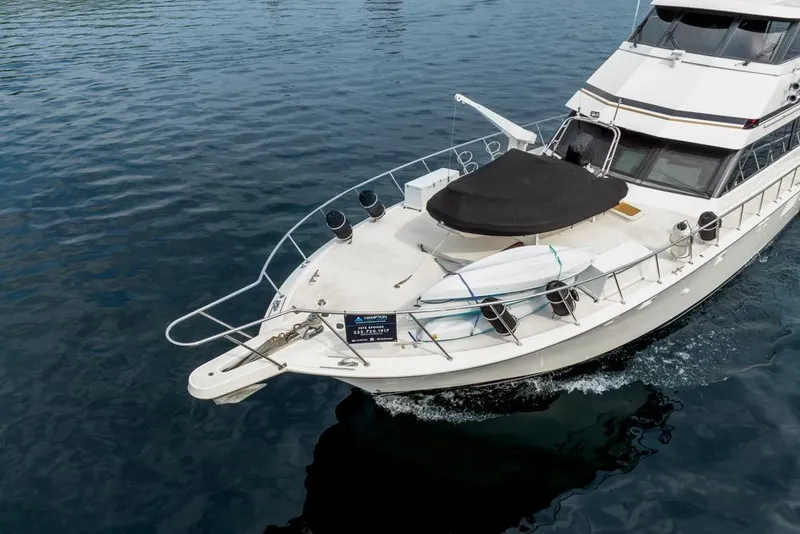 Slide: The Image of 1988 Hatteras 65 Sportfish yacht cruising on calm blue waters. - 8