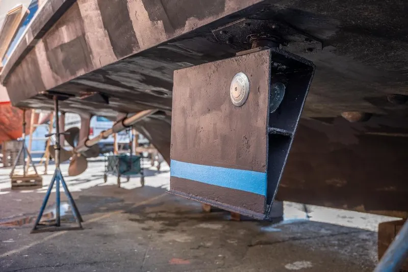 Slide: The Image of 1988 Hatteras 65 Sportfish boat underbody with propeller and stabilizer detail. - 80