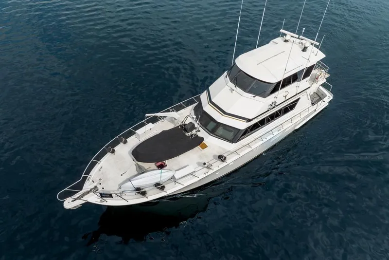 Slide: The Image of 1988 Hatteras 65 Sportfish yacht on calm blue water, aerial view. - 9