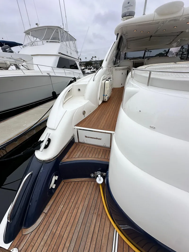Slide: The Image of 2000 Sunseeker Predator 60 yacht with teak deck, docked in marina. - 10