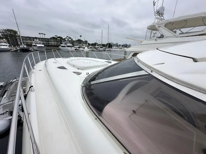 Slide: The Image of Sunseeker Predator 60 yacht, 2000 model, docked in a marina with overcast skies. - 16