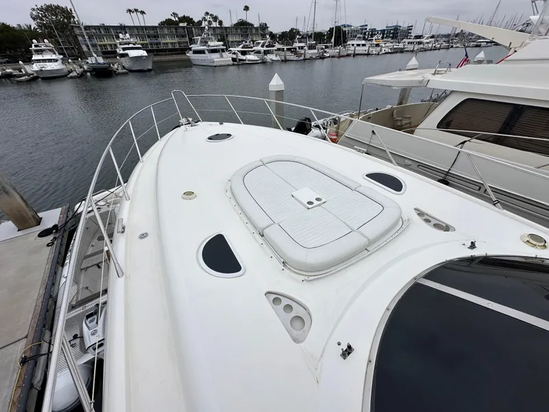 Slide: The Image of Sunseeker Predator 60 yacht, 2000 model, docked in a marina with other boats. - 17