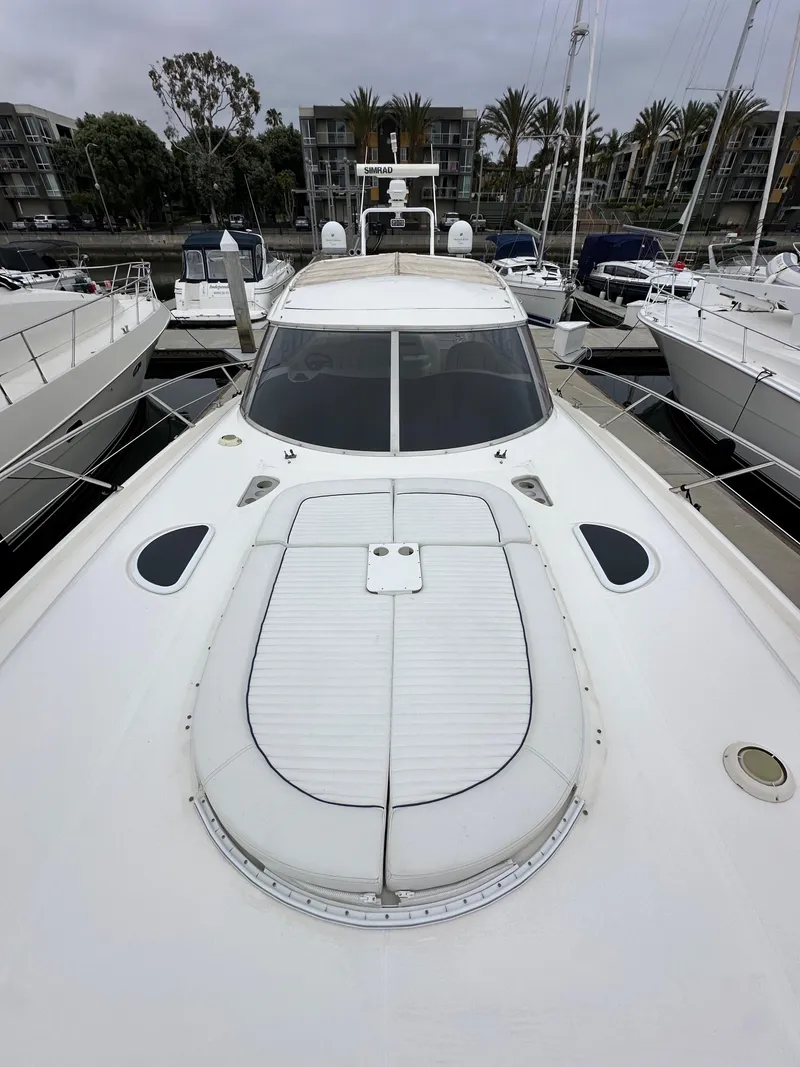 Slide: The Image of Sunseeker Predator 60 yacht, 2000 model, docked among other boats in a marina. - 23