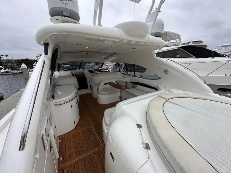 Slide: The Image of 2000 Sunseeker Predator 60 yacht interior with white seating and wooden deck. - 31