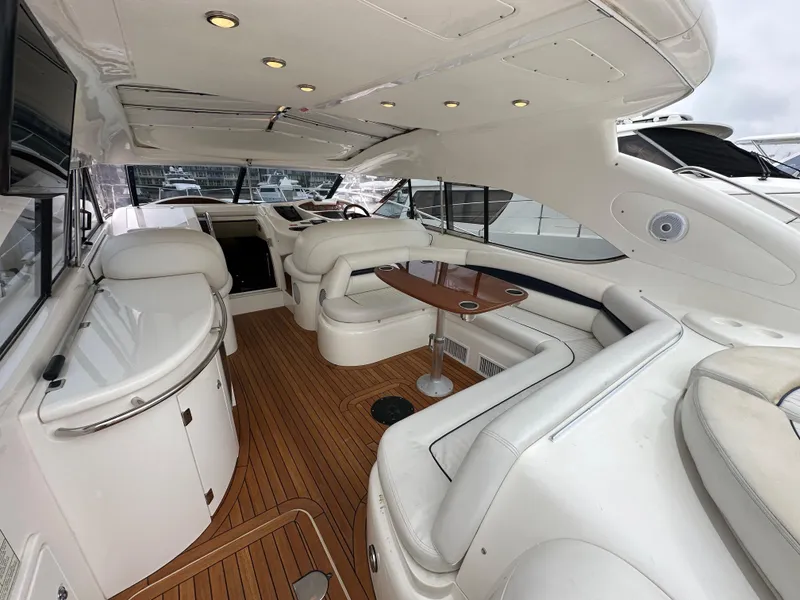 Slide: The Image of Luxurious interior of a 2000 Sunseeker Predator 60 yacht with white seating and wooden flooring. - 32