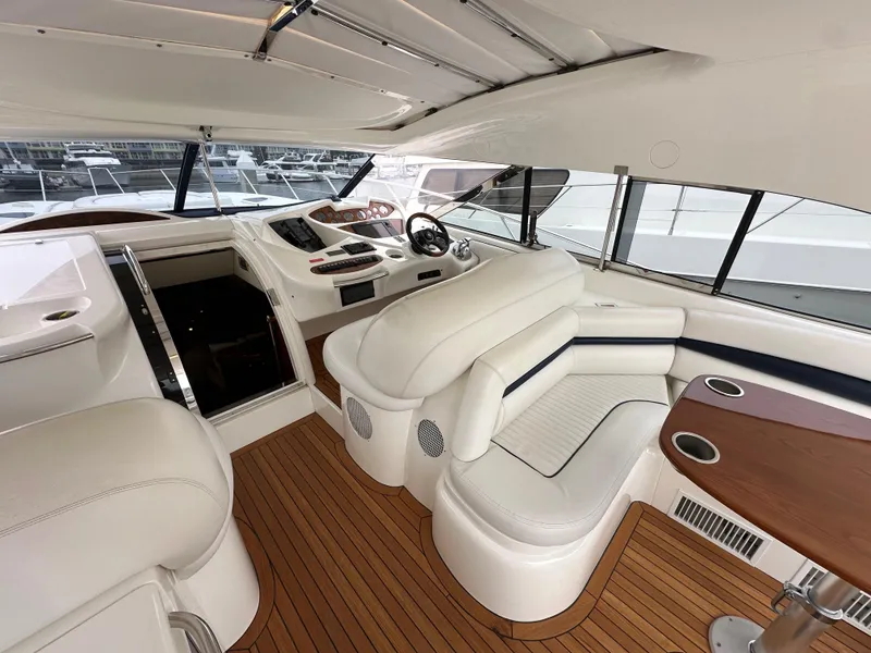 Slide: The Image of Interior of 2000 Sunseeker Predator 60 yacht with white seating and wooden flooring. - 38