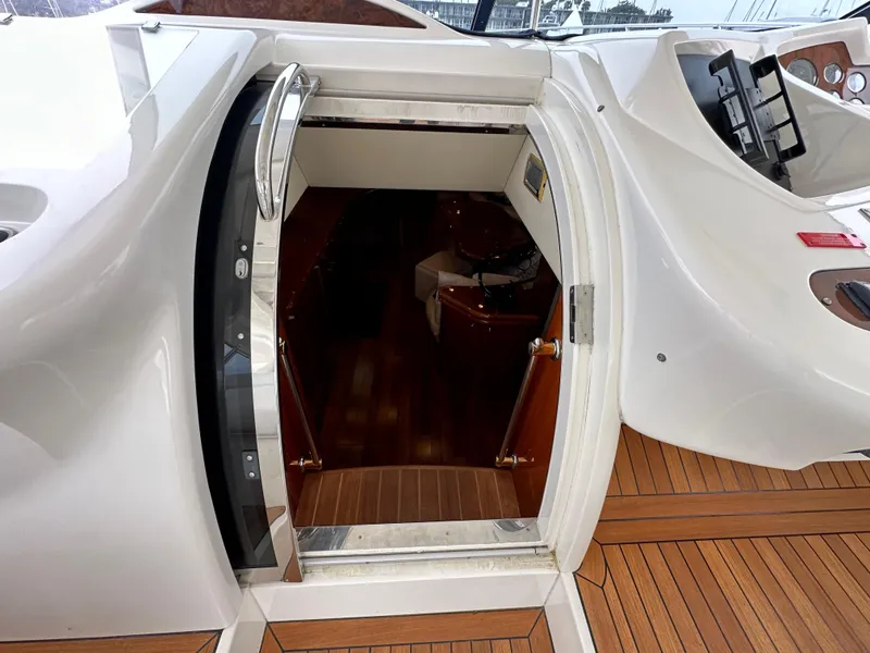 Slide: The Image of Sunseeker Predator 60 yacht entrance, showcasing sleek design and wooden flooring, year 2000 model. - 49