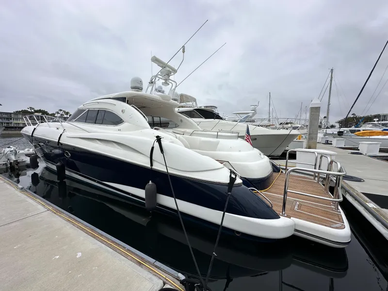 Slide: The Image of Sunseeker Predator 60 yacht, 2000 model, docked at marina under cloudy sky. - 5