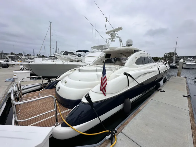 Slide: The Image of Sunseeker Predator 60 yacht, 2000 model, docked at marina with American flag. - 7