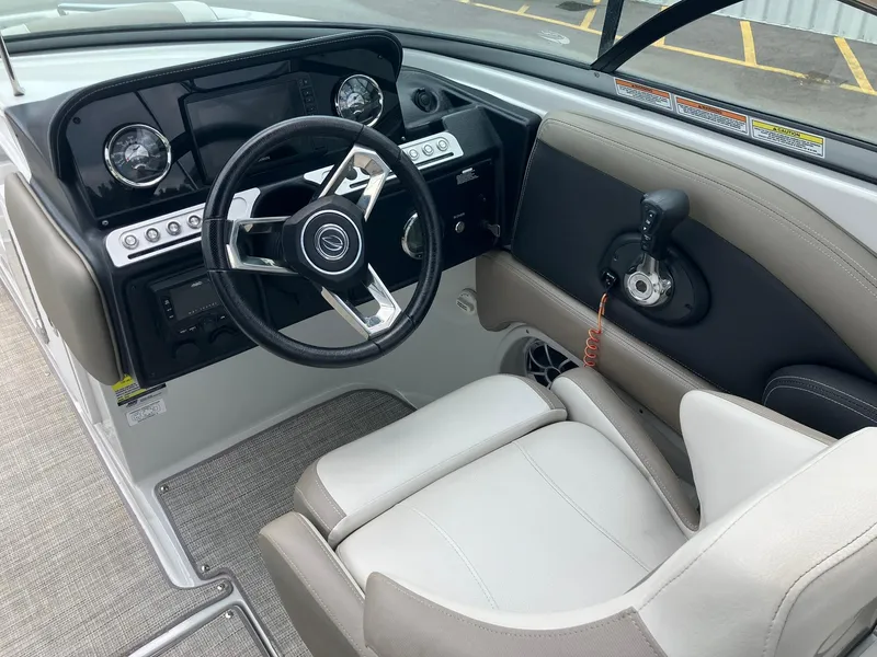 Slide: The Image of 2023 Crownline Eclipse E235 boat interior with steering wheel and control panel. - 10