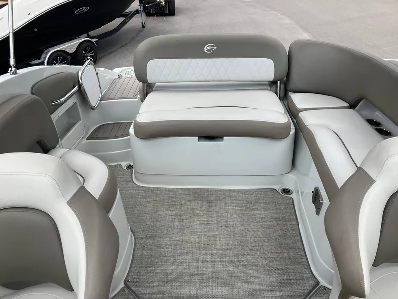 Slide: The Image of 2023 Crownline Eclipse E235 boat interior with gray and white seating, showcasing modern design. - 13