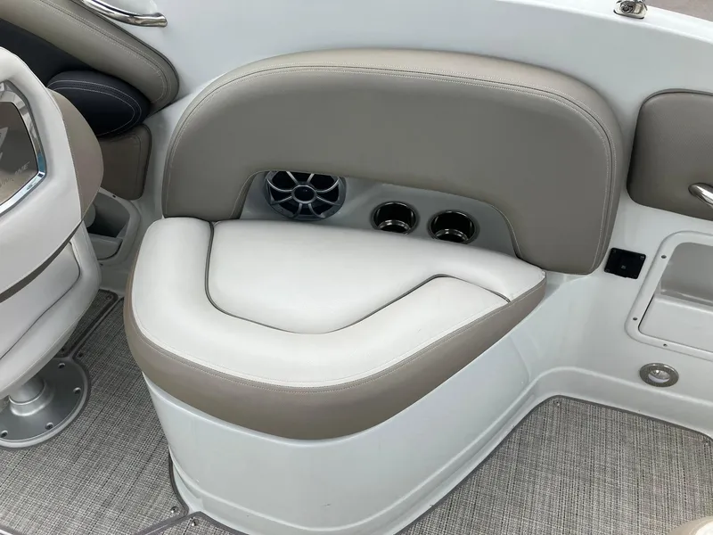 Slide: The Image of 2023 Crownline Eclipse E235 boat interior with beige seating and cup holders. - 15