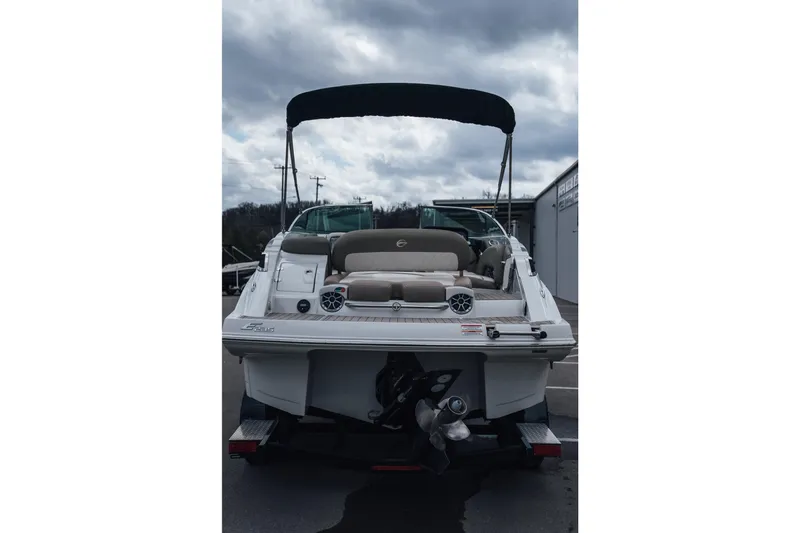 Slide: The Image of 2023 Crownline Eclipse E235 boat, rear view with seating and canopy, on a trailer. - 21