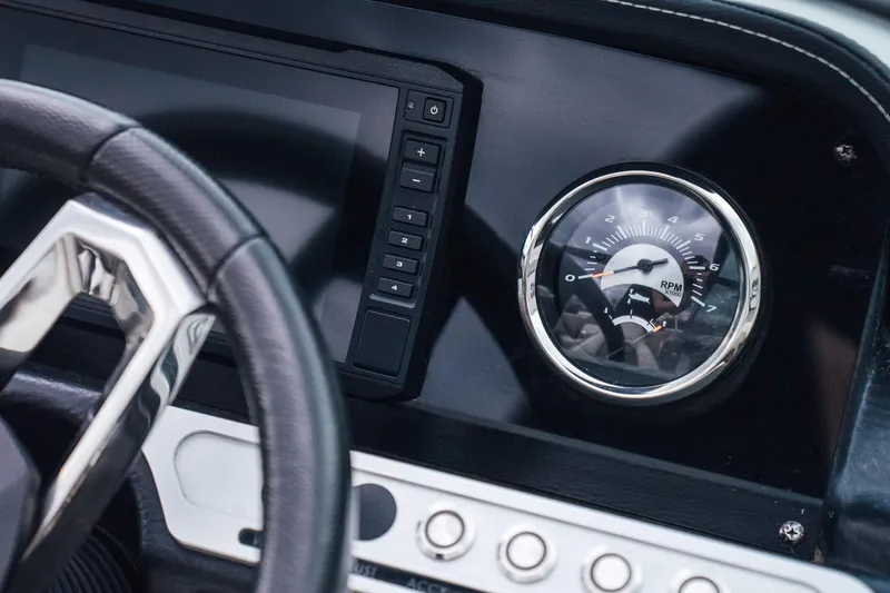 Slide: The Image of Dashboard of 2023 Crownline Eclipse E235 boat with RPM gauge and controls. - 22