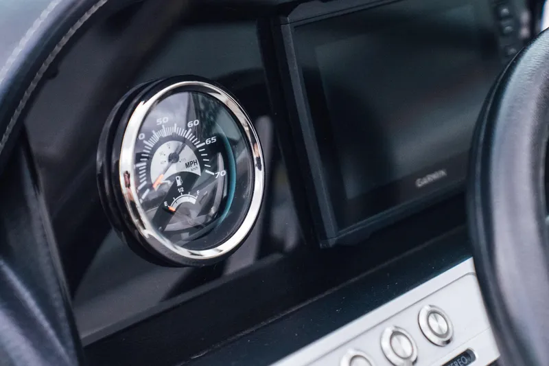 Slide: The Image of Dashboard of 2023 Crownline Eclipse E235 boat with speedometer and controls. - 23