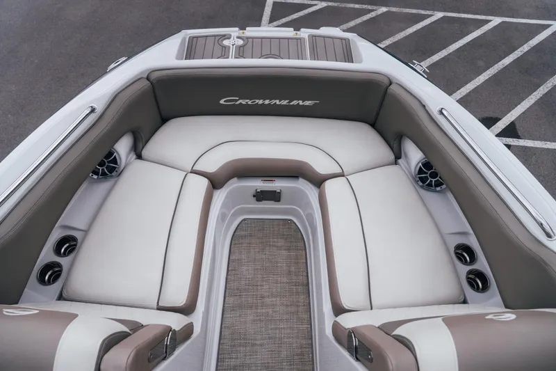 Slide: The Image of 2023 Crownline Eclipse E235 boat interior with plush seating and cup holders. - 24