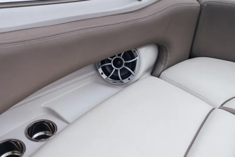 Slide: The Image of 2023 Crownline Eclipse E235 boat interior with speaker and cup holders. - 25