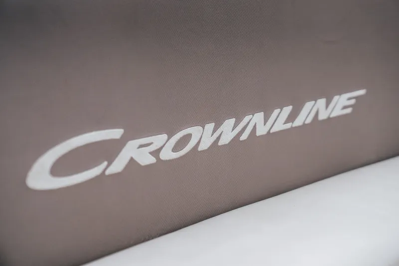 Slide: The Image of Crownline Eclipse E235 2023 logo on boat upholstery, showcasing luxury design. - 26