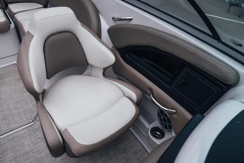Slide: The Image of 2023 Crownline Eclipse E235 boat interior with beige and white seating. - 28