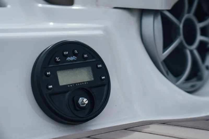 Slide: The Image of Close-up of audio controls on 2023 Crownline Eclipse E235 boat. - 34