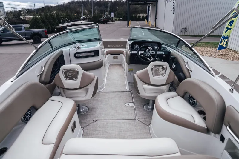 Slide: The Image of 2023 Crownline Eclipse E235 boat interior with beige seating and modern dashboard. - 38