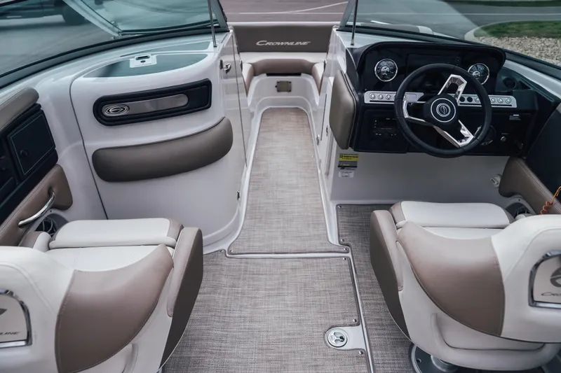 Slide: The Image of 2023 Crownline Eclipse E235 boat interior with modern dashboard and comfortable seating. - 40