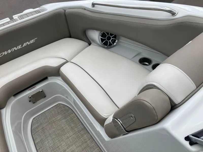 Slide: The Image of 2023 Crownline Eclipse E235 boat interior with beige seating and speaker. - 6