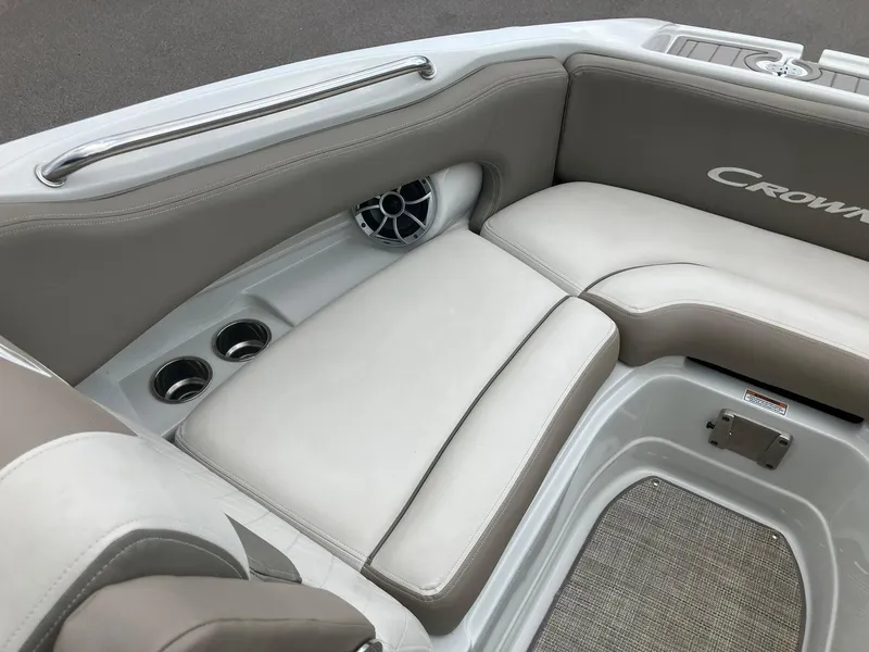 Slide: The Image of 2023 Crownline Eclipse E235 boat interior with cushioned seating and cup holders. - 7