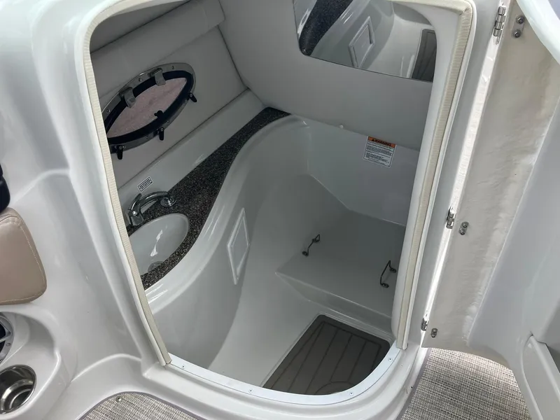 Slide: The Image of 2023 Crownline Eclipse E235 boat interior with sink and porthole window. - 9