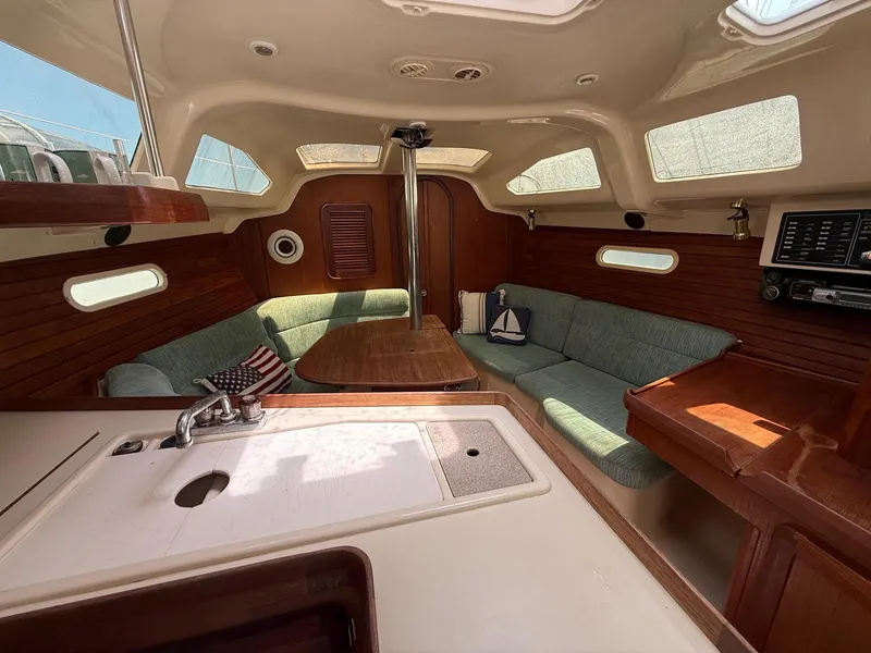 Slide: The Image of Interior of 1995 Hunter 336 sailboat with cozy seating and wooden accents. - 3