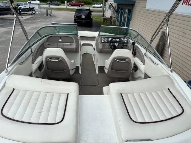 Slide: The Image of 2005 Cobalt 200 boat interior with white seating and steering console. - 10