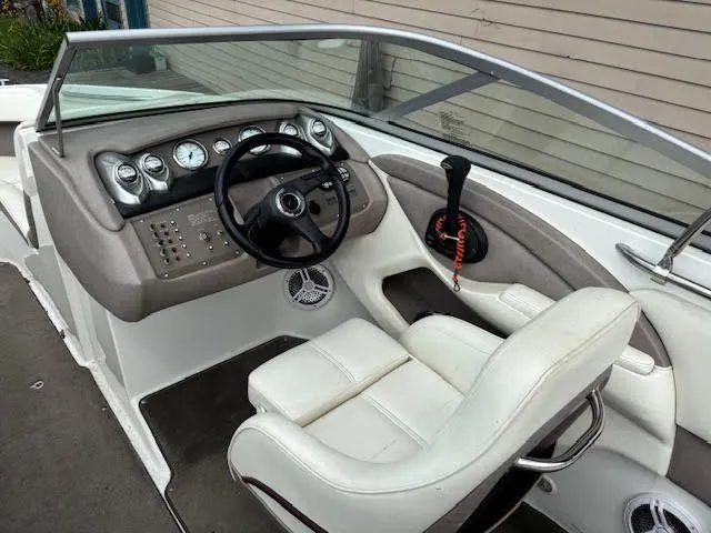 Slide: The Image of Interior of a 2005 Cobalt 200 boat with steering wheel and dashboard controls. - 13
