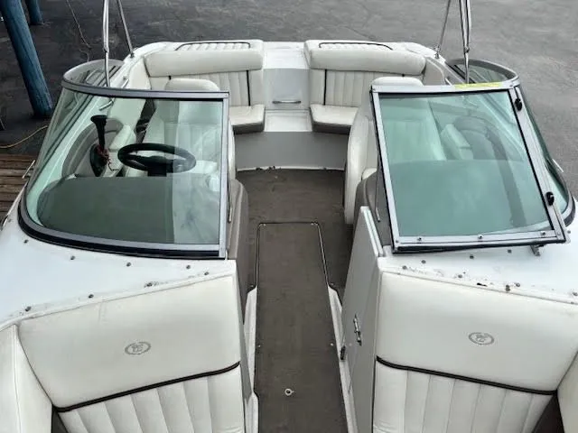Slide: The Image of 2005 Cobalt 200 boat interior with white seating and open windshield. - 17