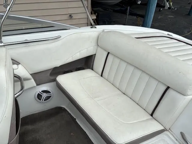Slide: The Image of 2005 Cobalt 200 boat interior with white cushioned seating and speaker. - 20