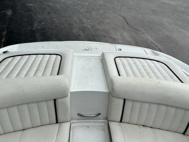 Slide: The Image of 2005 Cobalt 200 boat interior with white cushioned seating and sleek design. - 21