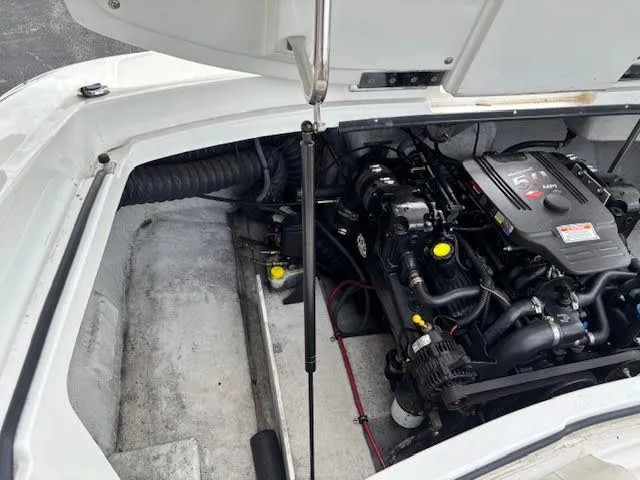 Slide: The Image of Engine compartment of a 2005 Cobalt 200 boat, showcasing the motor and components. - 24