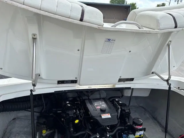 Slide: The Image of 2005 Cobalt 200 boat engine compartment with open hatch, showcasing engine details. - 25