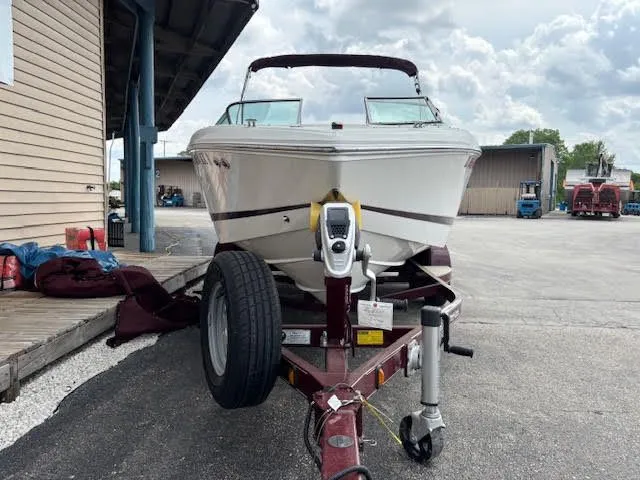Slide: The Image of 2005 Cobalt 200 boat on trailer, parked outdoors near a building. - 3