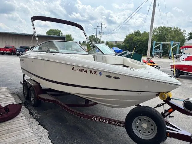 Slide: The Image of 2005 Cobalt 200 boat on trailer, parked outdoors, with overcast sky. - 4