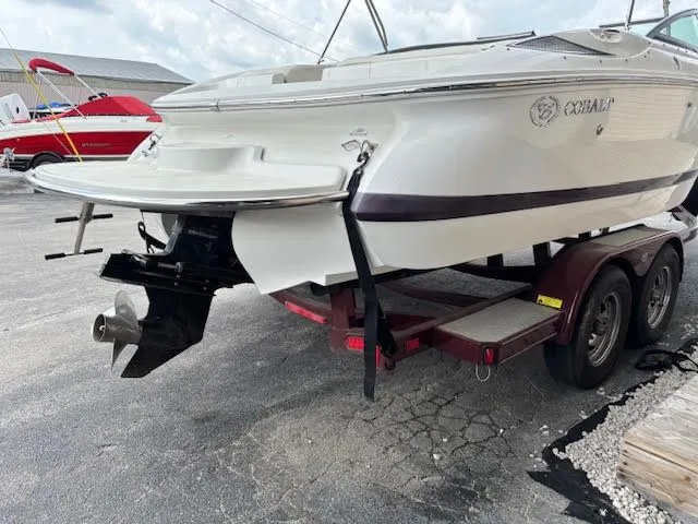 Slide: The Image of 2005 Cobalt 200 boat on trailer, rear view, white hull, outdoor setting. - 7
