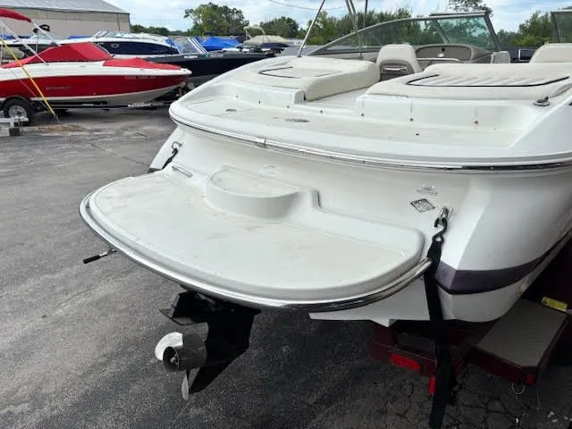 Slide: The Image of 2005 Cobalt 200 boat with swim platform and outboard motor in a marina setting. - 8